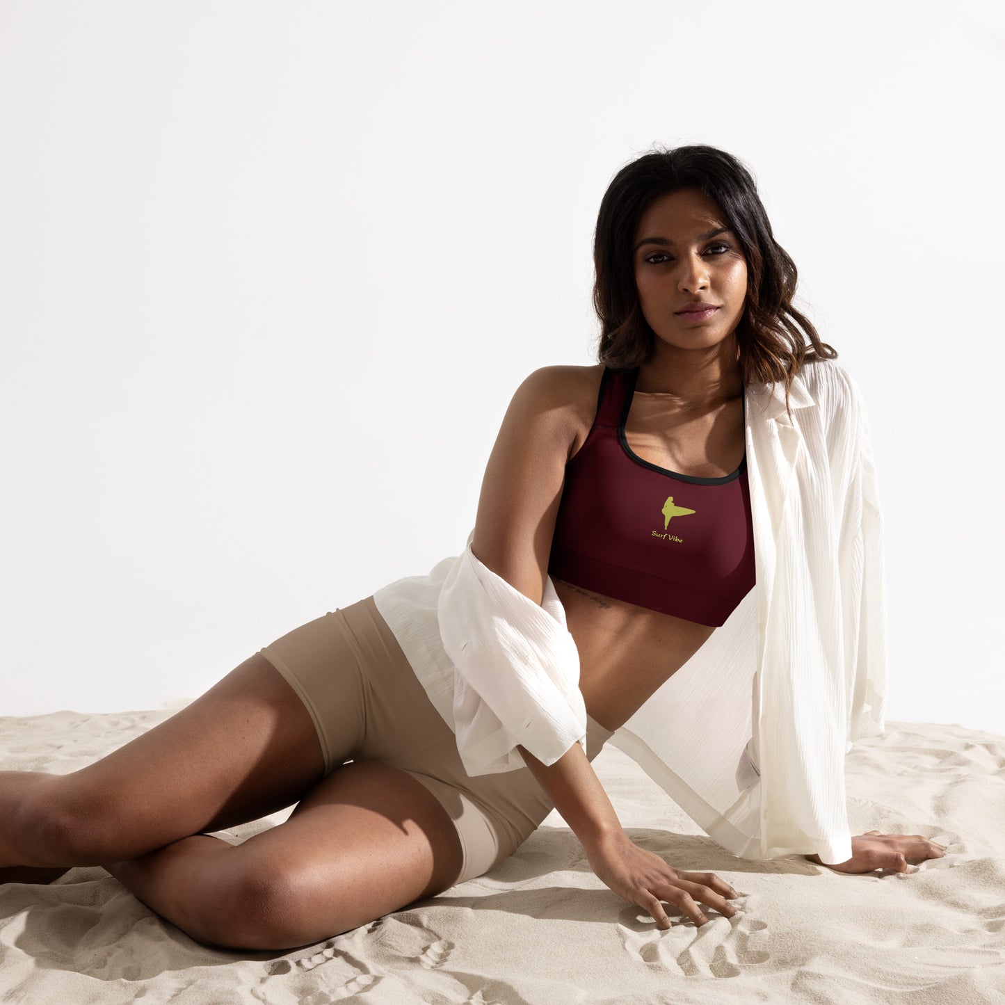 Activewear for women. surf inspired padded sport bra burgundy and anis with a surfer tattoo